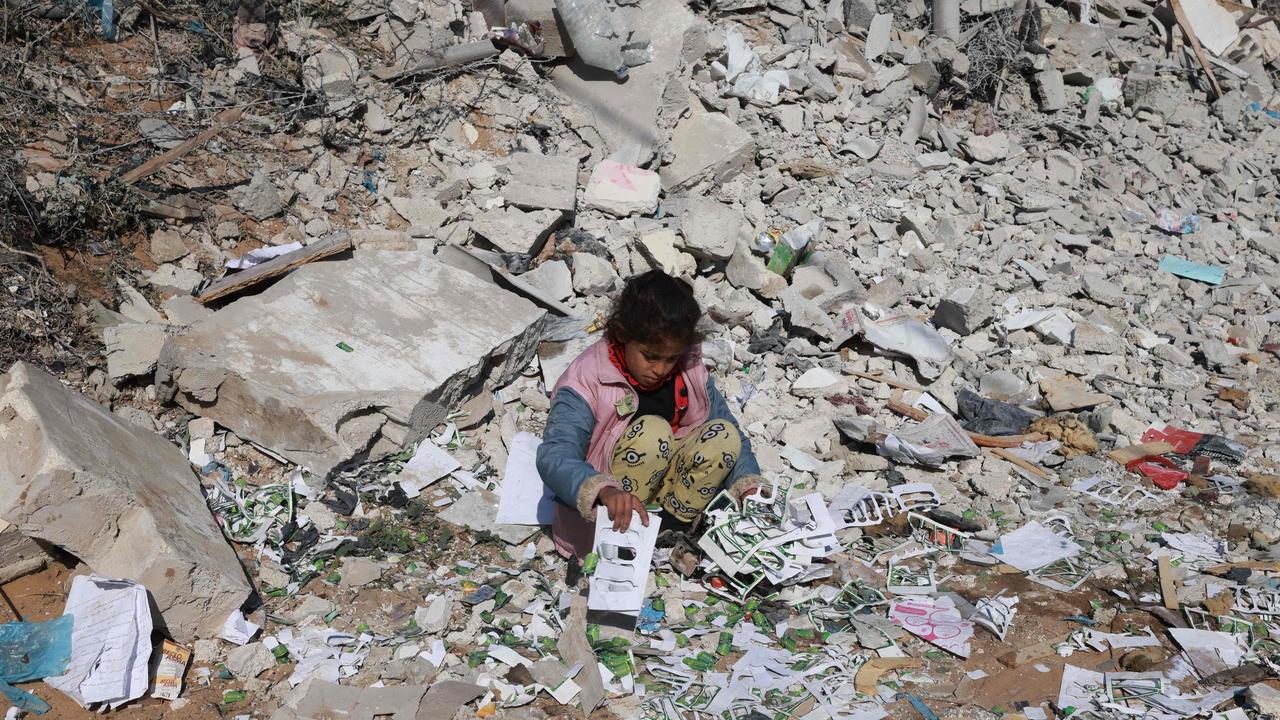 A Palestinian girl looks for salvageable items amid the destruction on the southern outskirts of Khan Yunis in the war-battered Gaza Strip. Picture: AFP