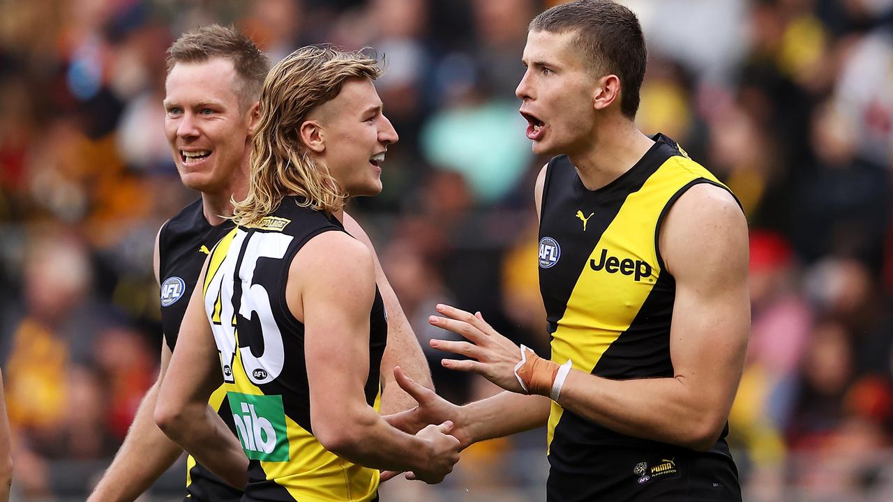 SYDNEY, AUSTRALIA - MAY 30: Callum Coleman-Jones of the Tigers celebrates with Jack Riewoldt and Hugo Ralphsmith of the Tigers after kicking a goal during the round 11 AFL match between the Richmond Tigers and the Adelaide Crows at GIANTS Stadium on May 30, 2021 in Sydney, Australia. (Photo by Mark Kolbe/AFL Photos/via Getty Images)