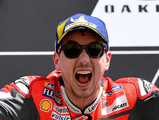 Ducati Team's Spanish rider Jorge Lorenzo celebrates on the podium after winning the Moto GP Grand Prix at the Mugello race track on June 3, 2018 / AFP PHOTO / TIZIANA FABI