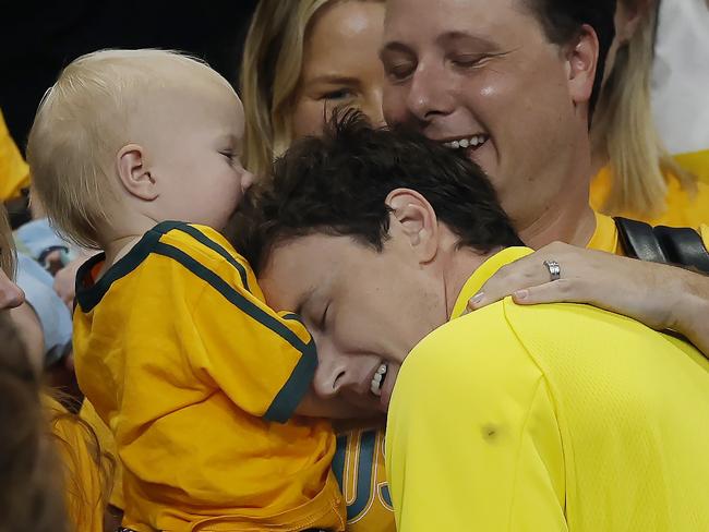 Cam McEvoy hugs his family after winning the 50 metres freestyle . Picture: Michael Klein