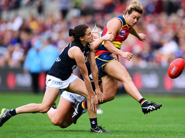 Courtney Cramey of the Adelaide Crows kicks under pressure during the AFLW Grand Final match between Adelaide and Carlton in 2019. Picture: Mark Brake/Getty Images