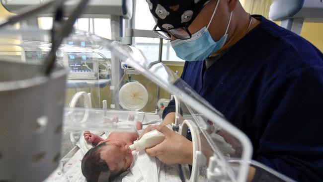 A medical worker feeds a newborn baby in the paediatric ward of a hospital in Fuyang in China's eastern Anhui province last April. Picture: AFP.