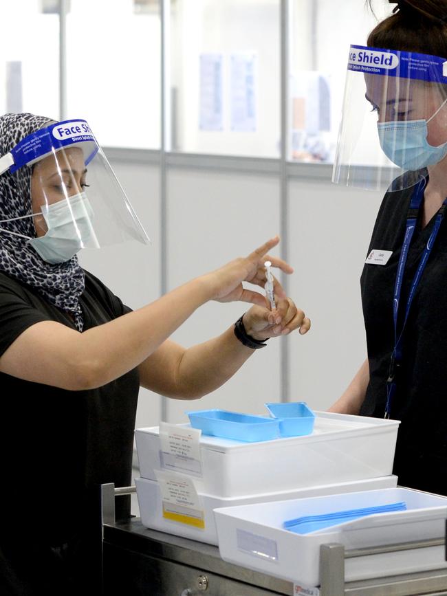 Medical staff at the Melbourne Convention and Exhibition Centre preparing to administer Covid vaccinations. Picture: NCA NewsWire