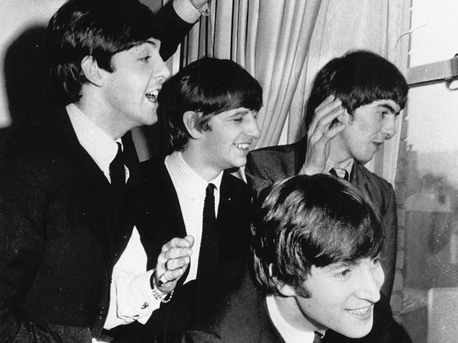 The Beatles wave to fans assembled below their Plaza Hotel window after they arrived in New York City on Feb. 7, 1964 for a short tour of the United States. Picture: AP Photo