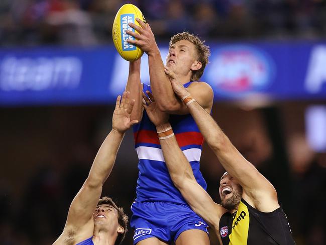 MELBOURNE, AUSTRALIA - MAY 04: Aaron Naughton of the Bulldogs marks the ball over Noah Balta of the Tigers during the round seven AFL match between the Western Bulldogs and the Richmond Tigers at Marvel Stadium on May 04, 2019 in Melbourne, Australia. (Photo by Michael Dodge/Getty Images)