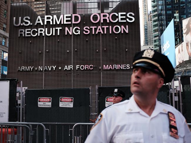 A police officer stands guard as protesters gather in Times Square, New York City, in July to show their anger at President Donald Trump's decision to reinstate a ban on transgender individuals from serving in the military. Picture: AFP Photo/Getty Images North America/Spencer Platt