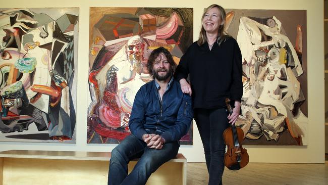 Musician/composer Amanda Brown with Australian painter Ben Quilty, with three of Quilty's current artworks exhibited at The Art Gallery of New South Wales in Sydney,. Picture: Britta Campion