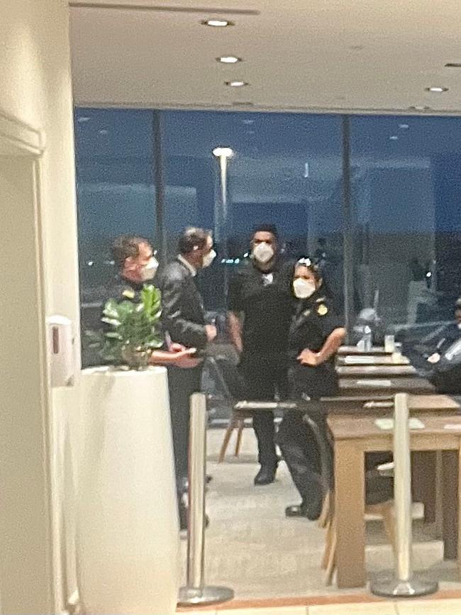 Djokovic under police guard in Melbourne Airport lounge as he's escorted out of the country. Picture: Facebook