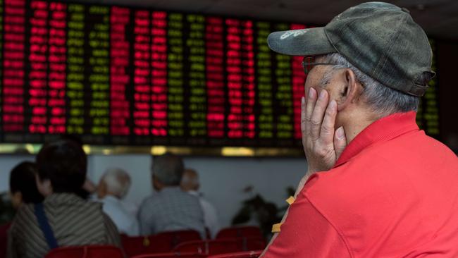 This photo taken on August 13, 2015 shows investors monitoring screens showing stock market movements at a brokerage house in Shanghai. Shanghai stocks were down 0.40 percent, or 15.01 points to 3,779.10, by the break on August 20, 2015, narrowing morning losses on expectations of more government support measures for equities following volatile trading the previous day, dealers said. AFP PHOTO / JOHANNES EISELE