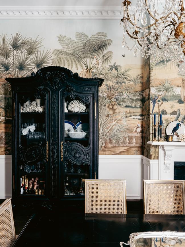 This ebonised 18th-century oak armoire highlights the white vessels and dinnerware stored inside.