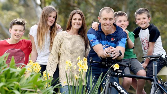 17/9/15 - Port Adelaide premiership player Michael Wilson at his home in Heathfield with Leah his wife and their four kids Noah, 13, Lucy, 11, and twins Tom (green t-shirt) and Charlie, 8. Tom recently had surgery to remove a brain tumour. The whole family is going to cheer Michael on in the Hawaii Ironman in October. Photo Naomi Jellicoe