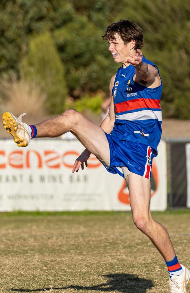 Kai Wunderly boots Mornington forward. Picture: Alan Dillon