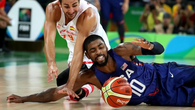 Ricky Rubio #79 of Spain and Kyrie Irving #10 of United States dive for the loose ball.
