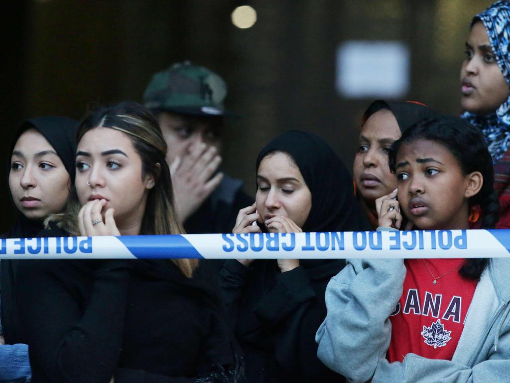 Locals watch as Grenfell Tower is engulfed by the fire, trapping an unknown number of residents. Picture: AFP Photo/Daniel Leal-Olivas