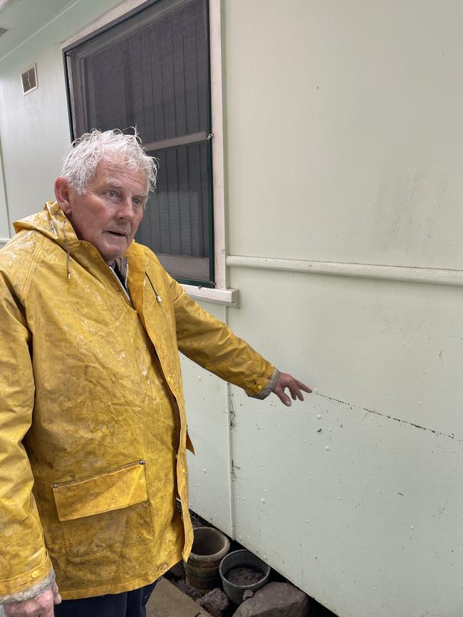 Bernard King points out how high the flood waters rose in his home by the Georges River on July 3. He was waiting for an acquisition offer when the floods hit. Picture: Paul Brescia