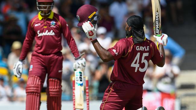 Still box office: Chris Gayle (R) celebrates an ODI century against England. Picture: AFP