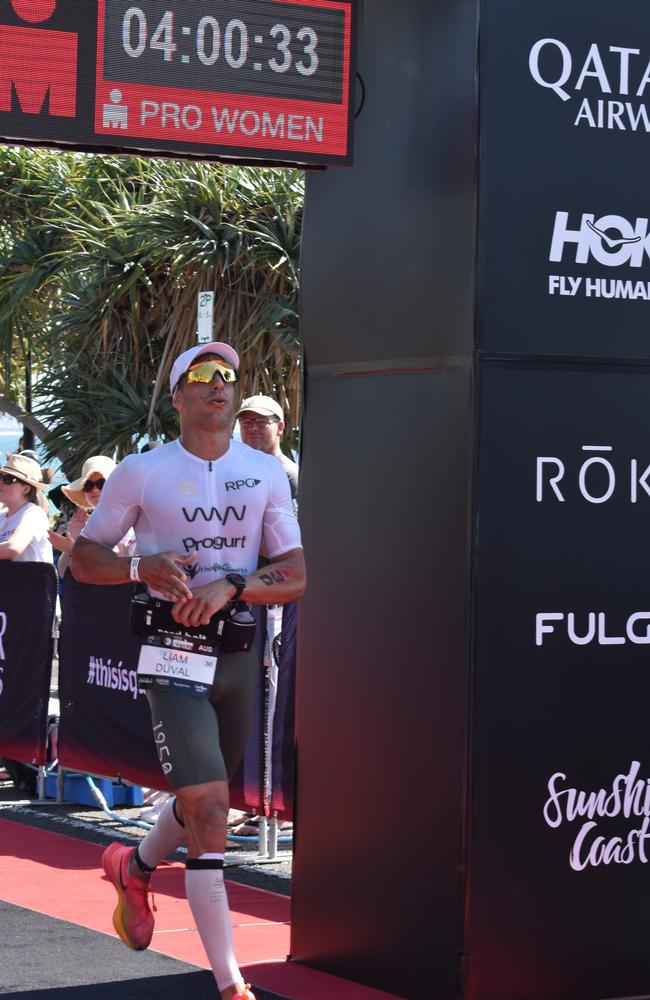 Athletes crossing the finish line at Sunshine Coast Ironman 70.3 2023.