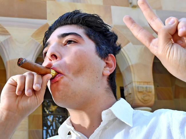 Drew Pavlou lights a ‘victory’ cigar at the University of Queensland after the <span style="font-family: Merriweather, Georgia, &#34;Times New Roman&#34;, Times, serif; font-size: 11pt;">announcement of a federal inquiry into Chinese interference at universities.<span style="font-family: Merriweather, Georgia, &#34;Times New Roman&#34;, Times, serif; font-size: 11pt;"> Picture: NewsWire / John Gass</span></span>