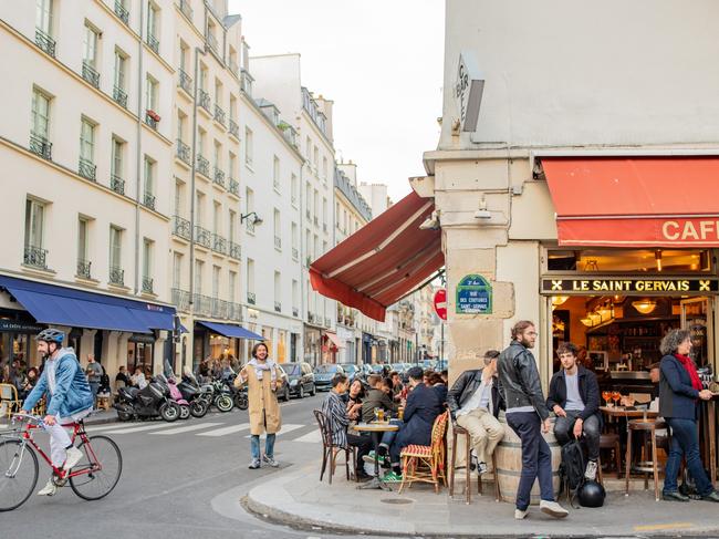 ESCAPE:  Paris / France - May 16, 2018: Friends hang out talking and laughing at a cafe in the evening in the popular Saint-Germain des Pres neighborhood, known for its vibrant nightlife. Picture: Istock