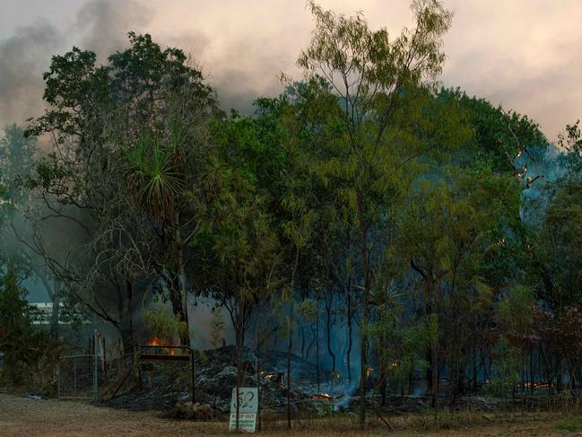 Twenty-five firefighting crews and residents successfully contained a bushfire threatening a number of homes in Darwin’s rural area. Picture: Che Chorley