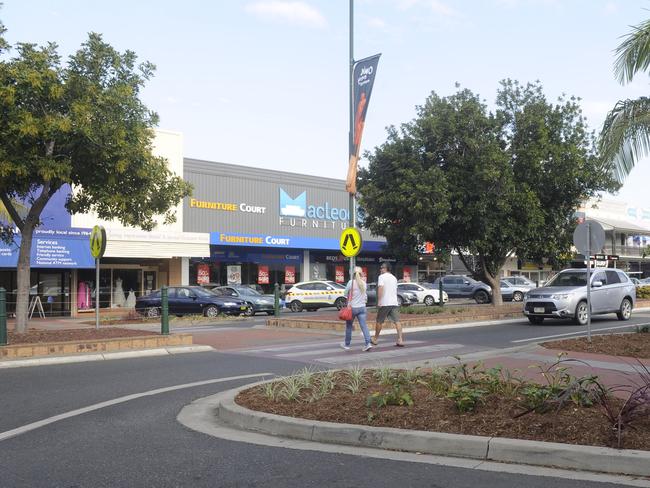 CROSSING: Two pedestrians cross the road in Grafton's CBD. Gardens in the centre strip have been blamed to reduce pedestrian visibility.