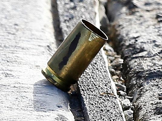 Police at the scene of a shooting involving up to 18 youths at Labrador. The empty bullet casing at the scene.. Picture Glenn Hampson