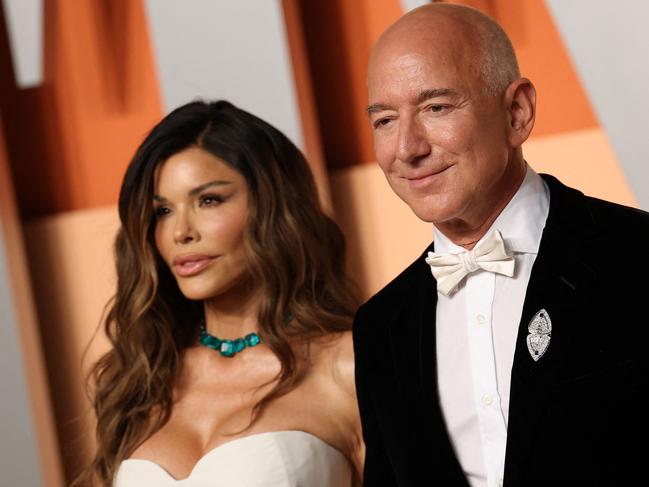 CEO of Amazon Jeff Bezos and partner Lauren Sanchez attend the Vanity Fair Oscar Party at the Wallis Annenberg Center for the Performing Arts in Beverly Hills, California, on March 2, 2025. (Photo by Michael Tran / AFP)