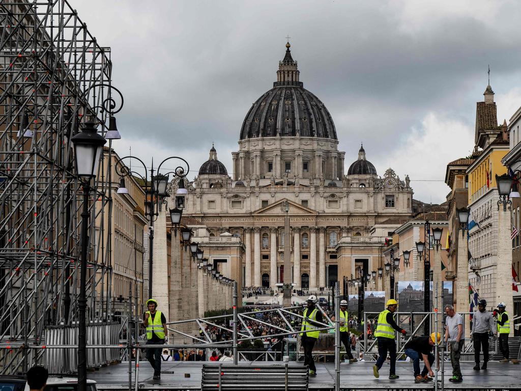 Workers build a tribune with the St Peter's Basilica of the Vatican in the background, on Via della Conciliazione street in Rome. Picture: AFP