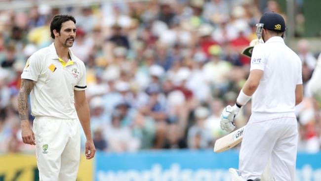 Mitchell Johnson stares at Joe Root during last year’s Ashes series. Picture: Calum Robertson.