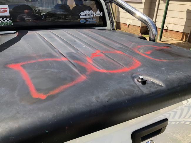 The word ‘dog’ was spray-painted on this car while two of the windows were smashed.