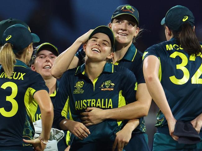 SHARJAH, UNITED ARAB EMIRATES - OCTOBER 13: Phoebe Litchfield of Australia celebrates with team mates after running out Rch during the ICC Women's T20 World Cup 2024 match between India and Australia at Sharjah Cricket Stadium on October 13, 2024 in Sharjah, United Arab Emirates.  (Photo by Francois Nel/Getty Images)