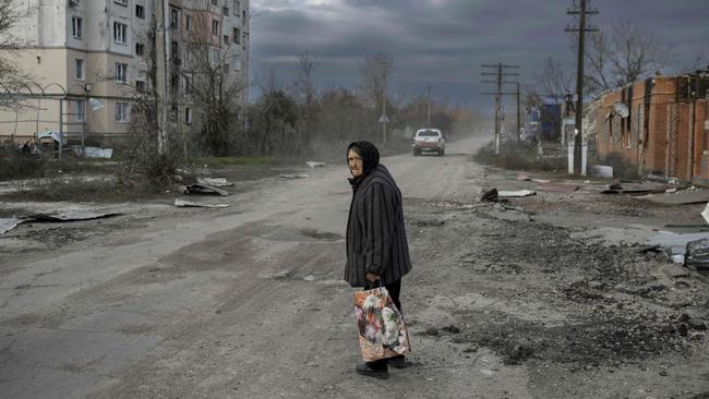 TOPSHOT – An old woman walks in the Kherson region village of Arkhanhelske on November 3, 2022, which was formerly occupied by Russian forces. (Photo by BULENT KILIC / AFP)