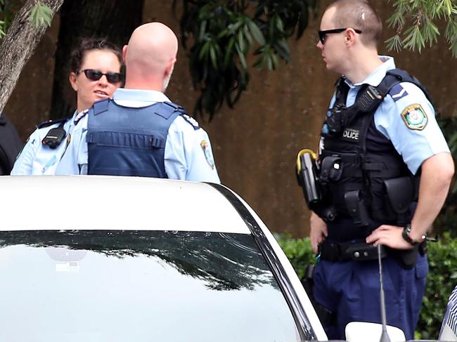 Police leaving Channel 9 after the meeting. Picture: DIIMEX