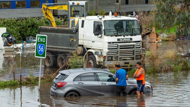 Drivers struggled with floodwaters in Newport as a huge deluge hit Melbourne. Trains have also been suspended. Picture: Mark Stewart