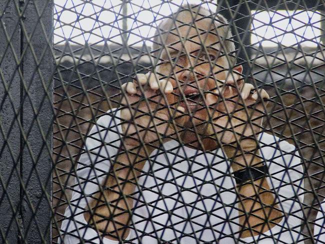 Award winning journalist in the defendants’ cage in an Egyptian courtroom on Monday. Picture: AP Photo/Hamada Elrasam