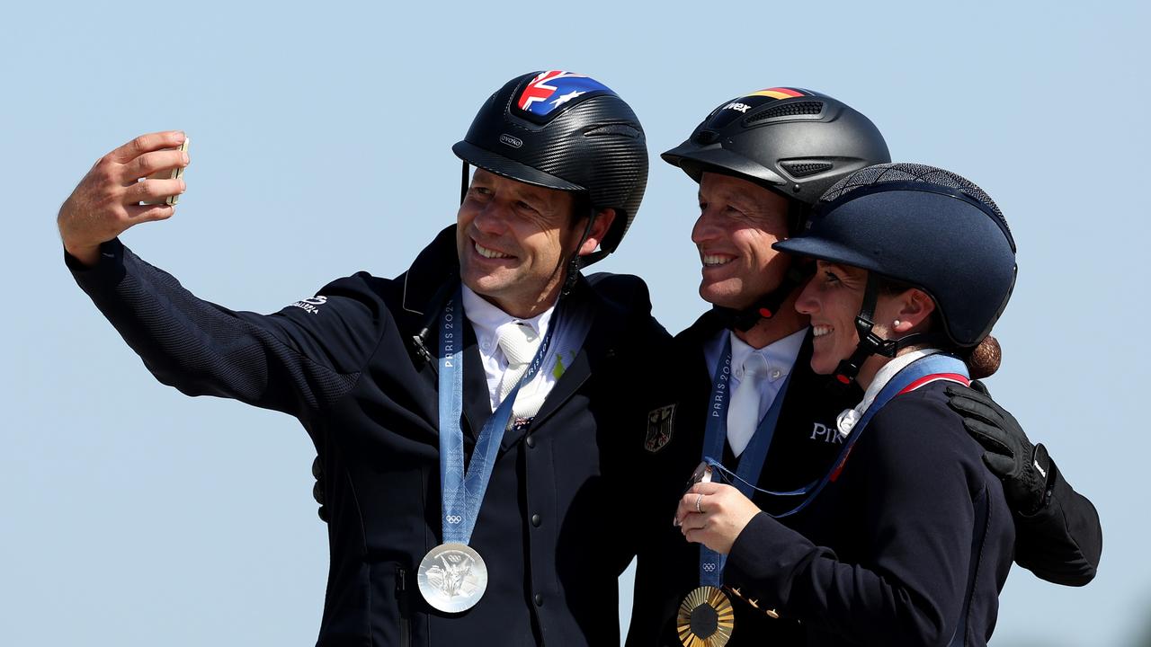 Christopher Burton (left) poses for a photo with fellow medallists Michael Jung and Laura Collett after the Eventing Individual Final. Picture: Getty Images