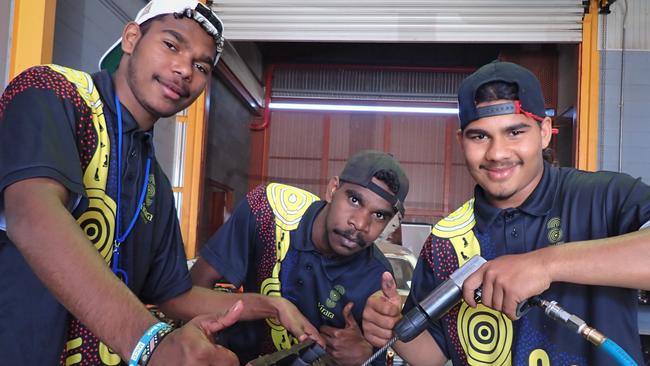 First Nations men from Yirara College engaged in work to restore a 1960s ‘Cuz Congress’ Valiant at CDU in Alice Springs. Picture: Charles Darwin University