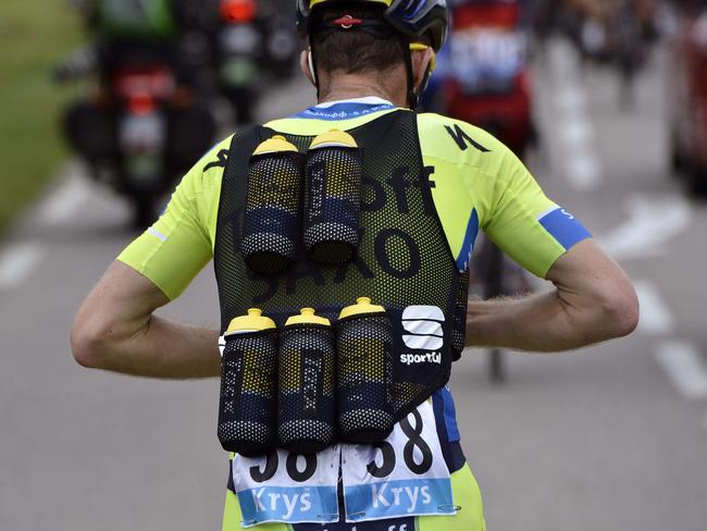 Poland's Rafal Majka rides as he transports water bottles for his Tinkoff-Saxo teammates.