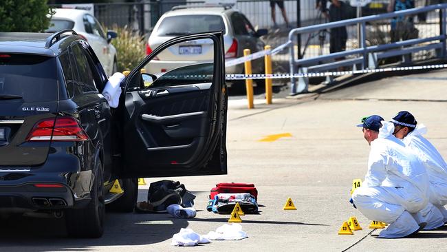 Forensic police collect bullet casings from the scene. Picture: Toby Zerna