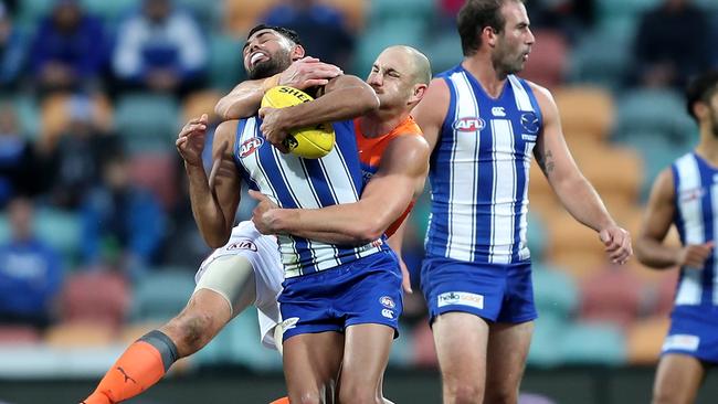 HOBART, AUSTRALIA - JUNE 13: Tarryn Thomas of the Kangaroos is tackled by Shane Mumford of the Giants during the round 13 AFL match between the North Melbourne Kangaroos and the Greater Western Sydney Giants at Blundstone Arena on June 13, 2021 in Hobart, Australia. (Photo by Mark Metcalfe/AFL Photos/via Getty Images)