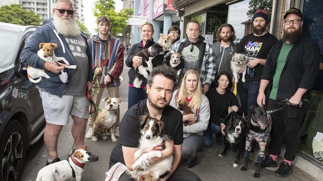 Bar Josephine owner Aaron Donato with customers, who are furious the dog-friendly venue has been banned from letting pooches inside. Picture: Ellen Smith