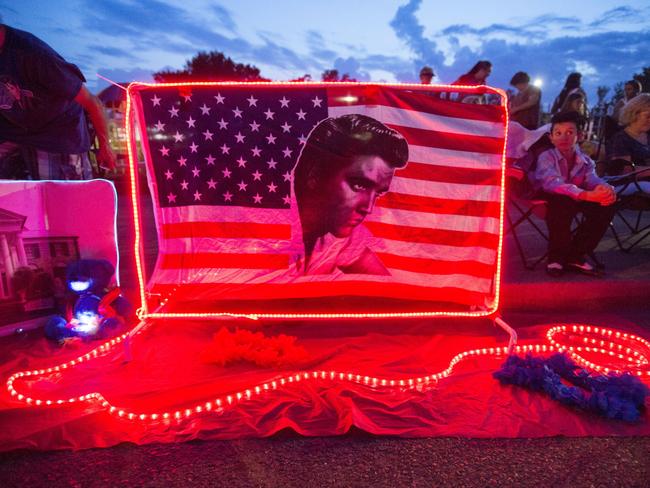 A street memorial outside Graceland is lit during the candlelight vigil held on the eve of the 40th anniversary of Elvis Presley’s death. Picture: AP