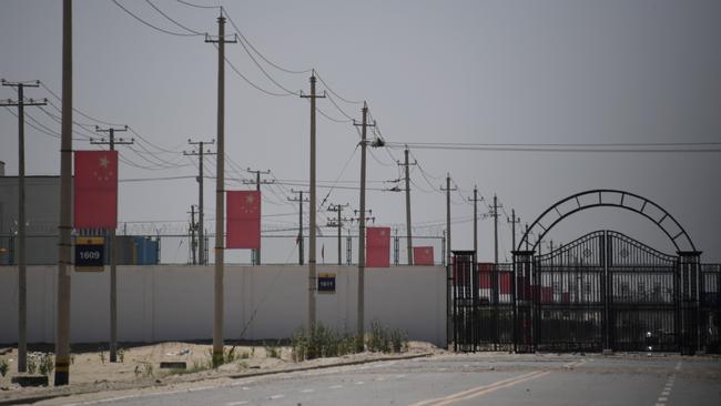 Chinese flags on a road leading to a facility believed to be a re-education camp where mostly Muslim ethnic minorities are detained, on the outskirts of Hotan in Xinjiang. Picture: AFP