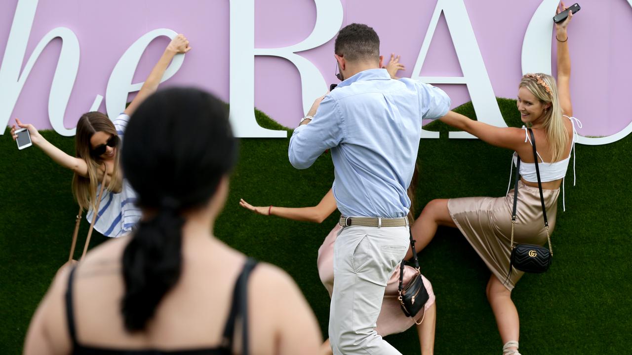 Racegoers enjoying the sun at Royal Randwick. Picture: Jonathan Ng