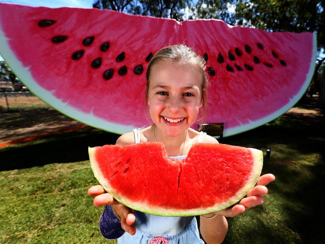 Tilly Hart, 10, from Chinchilla tries out the real thing in front of the big watermelon. Picture:  Adam Head