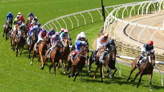 Jye McNeil riding Twilight Payment lead the field around the first bend in the Lexus Melbourne Cup. Picture: Quinn Rooney/Getty Images for the VRC