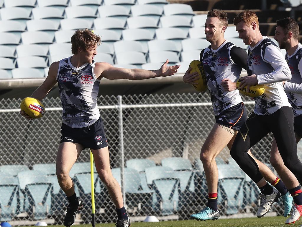 18/07/18 - AFL - Crows training (warm-up only) at Football park. Rory Sloane gestures to Brodie Smith as he runs with Tom Lynch and Rory Atkins. Picture SARAH REED