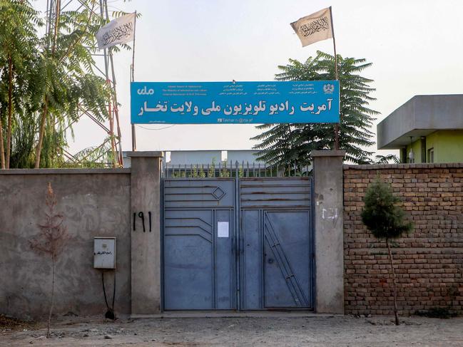 The Taliban flag flutters over a provincial branch building of National Radio Television of Takhar (RTA) in Taloqan, capital of northeastern Takhar province on October 15, 2024. At least two TV channels in a northern Afghan province stopped showing images of living beings during their broadcasts, journalists told AFP on October 15, in line with orders from morality police. (Photo by AFP)