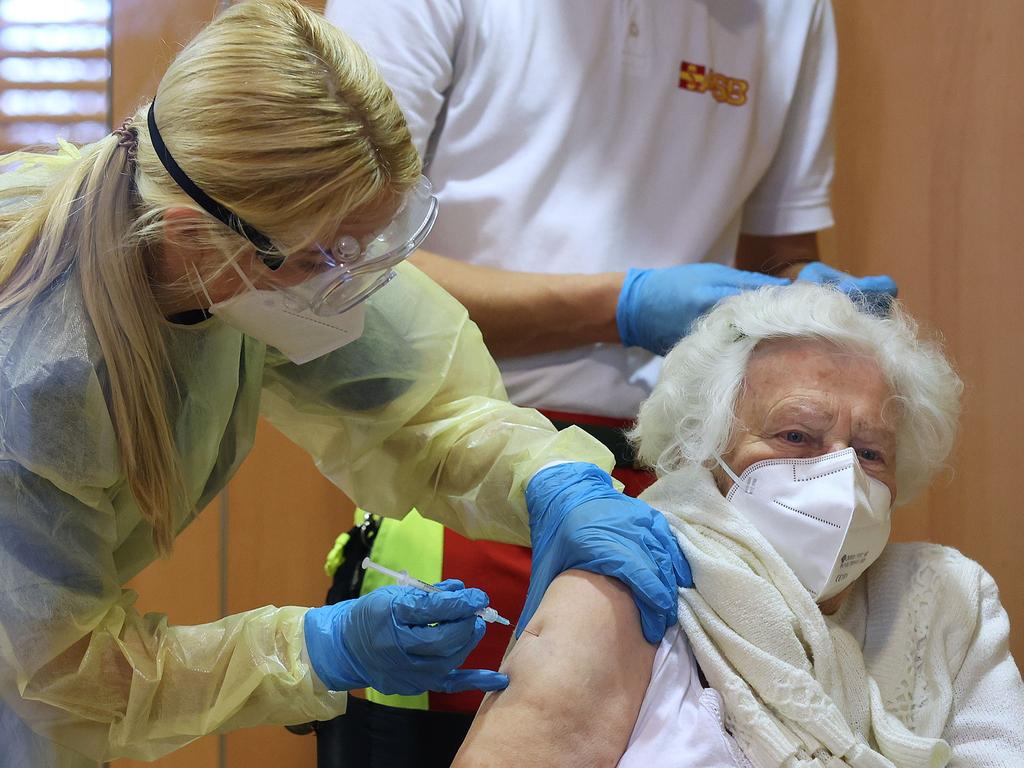 Ilse Zacharitz (R) is given a Pfizer-Biontech COVID-19 coronavirus vaccine by doctor Luisa Mecke at the 'Heideweg nursing home' in Magdeburg, eastern Germany. Picture: Ronny Hartmann / POOL / AFP.