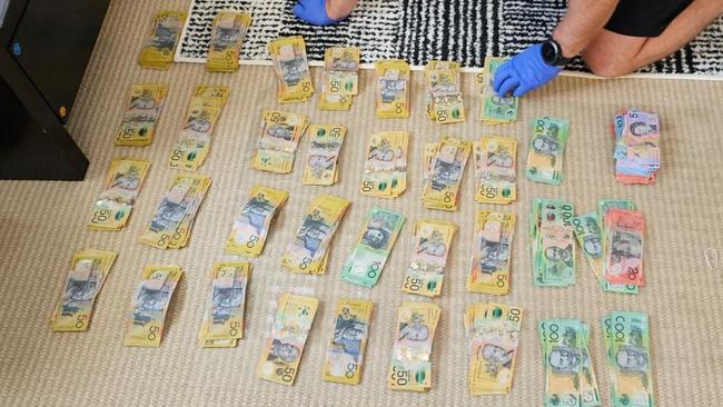 Police count out the $45,000 in cash seized following the search of a Fingal Bay property on October 11, 2023. Picture: Supplied.